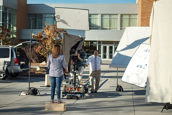 Production of Wagon Box Prophecy. Taylor Ray in front of the Taylor Building.