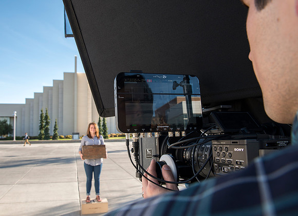 Production of Wagon Box Prophecy. Taylor Ray in front of the Taylor Building.