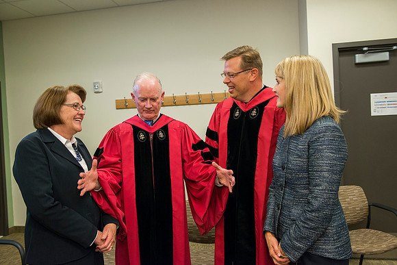 Elder and Sister Clark converse with the Gilberts.