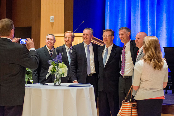 President Gilbert takes a photo with friends. Among them are past BYU roommates.