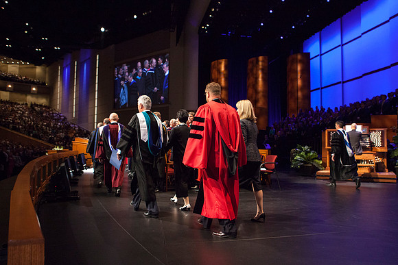 President Clark G. Gilbert and his wife Christine walk on stage during the Inauguration.