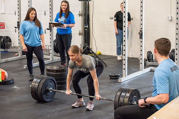 Men and Women compete in three rounds of weightlifting. Squat, Bench, and Deadlift.