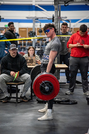 Men and Women compete in three rounds of weightlifting. Squat, Bench, and Deadlift.