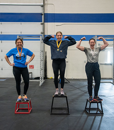 Men and Women compete in three rounds of weightlifting. Squat, Bench, and Deadlift.