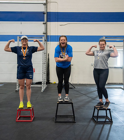 Men and Women compete in three rounds of weightlifting. Squat, Bench, and Deadlift.