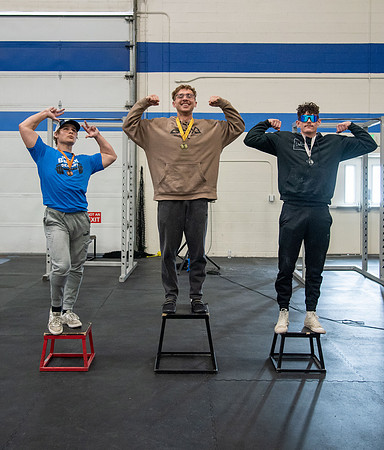 Men and Women compete in three rounds of weightlifting. Squat, Bench, and Deadlift.