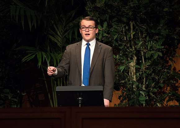 A student directs sacred music at a BYU-Idaho Devotional in Spring 2019.
