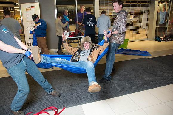Students learn to make hammocks out of parachute material.