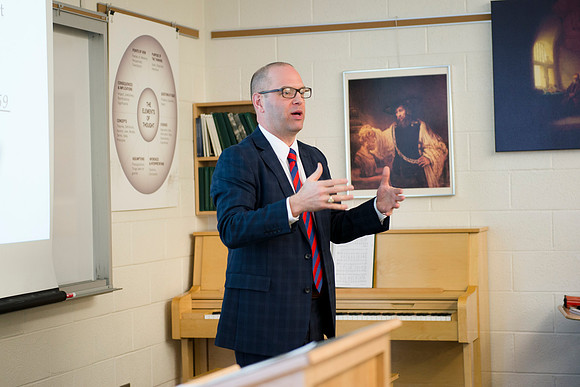 Brother Peterson, a religion professor, instructs students during the first week of school.