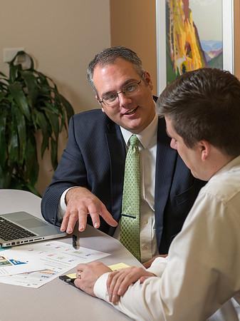 Arnold Thiebaud, Creative Services manager and Director of Marketing Communciations discusses a project with Jed Rhein the MarComm Graphic Designer.