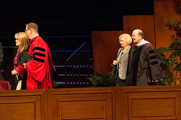 President Clark G. Gilbert and Elder Quentin L. Cook walking out in the graduation processional