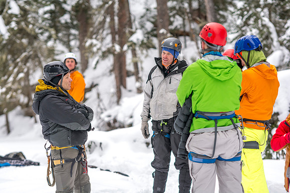 Scott Hurst (left), Dana Mitchell (middle) and others talking with eachother while out ice climbing.