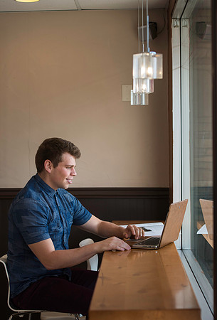 Blake Jensen studies for an Online class at the Cocoa Bean Cafe in Rexburg, ID.