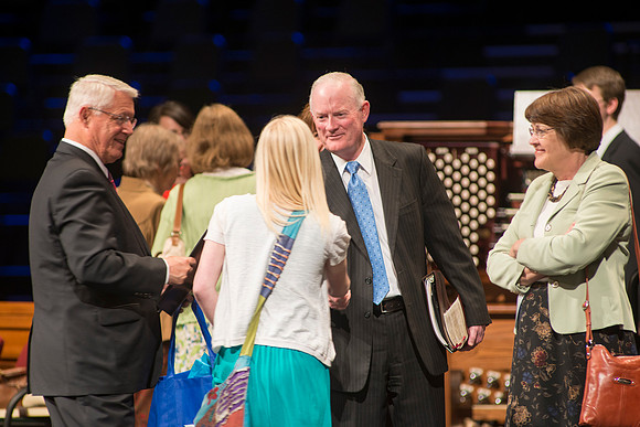 President and Sister Clark greet students after a devotional.