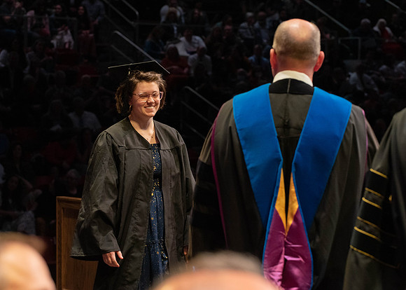 Students graduate and walk to receive their diplomas during convocation in the College of Physical Sciences and Engineering.