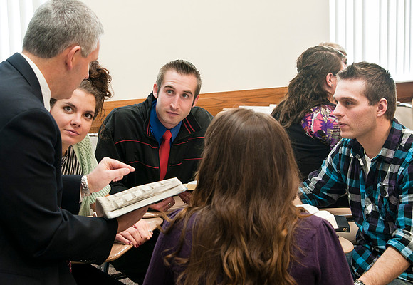 staged photo shoot of learning model in action with religion dept professor Lon Pyper.