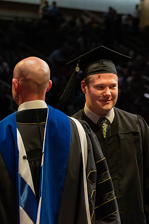 Students graduate and walk to receive their diplomas during convocation in the College of Physical Sciences and Engineering.