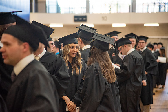Student Graduates and Faculty meet in the I-Center for Commencement.