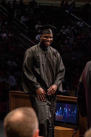 Students graduate and walk to receive their diplomas during convocation in the College of Physical Sciences and Engineering.
