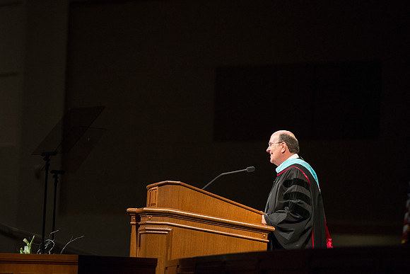 Elder Cook addresses the graduates during Commencement.