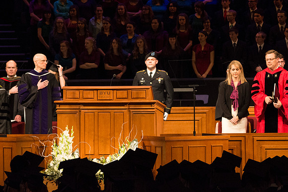 An ROTC member calls the colors at Commencement.