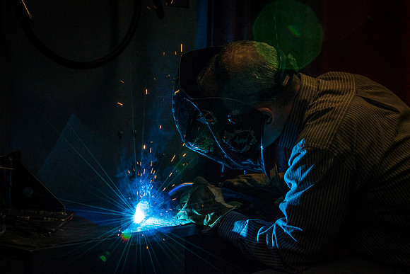 Clay Rasmussen, from the Mechanical Engineering Department, welds during a demonstration.