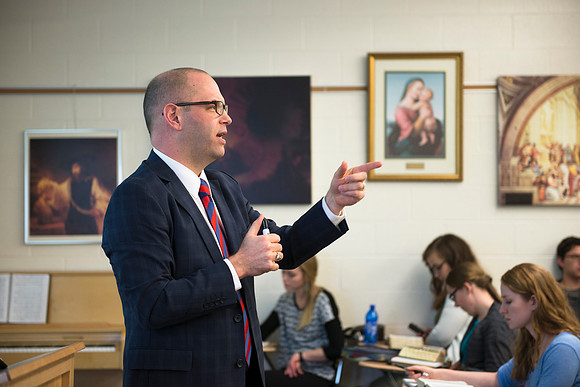 Brother Peterson, a religion professor, instructs students during the first week of school.
