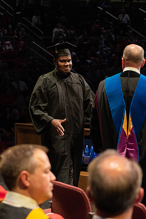 Students graduate and walk to receive their diplomas during convocation in the College of Physical Sciences and Engineering.