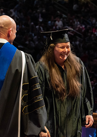 Students graduate and walk to receive their diplomas during convocation in the College of Physical Sciences and Engineering.