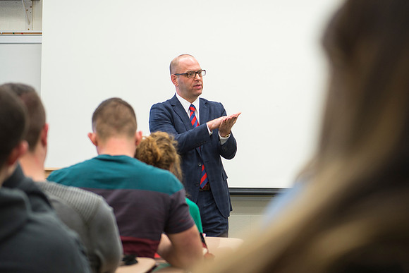 Brother Peterson, a religion professor, instructs students during the first week of school.