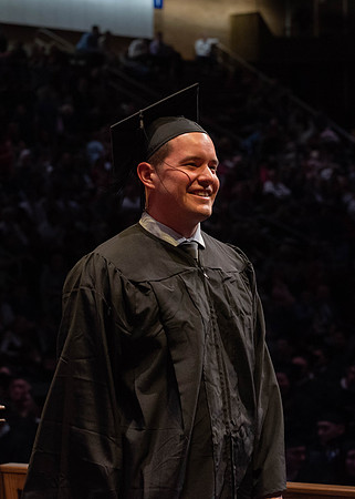 Students graduate and walk to receive their diplomas during convocation in the College of Physical Sciences and Engineering.