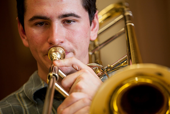 Roman Daves, a freshman at BYU-Idaho, practices with his trombone in the Snow Building.