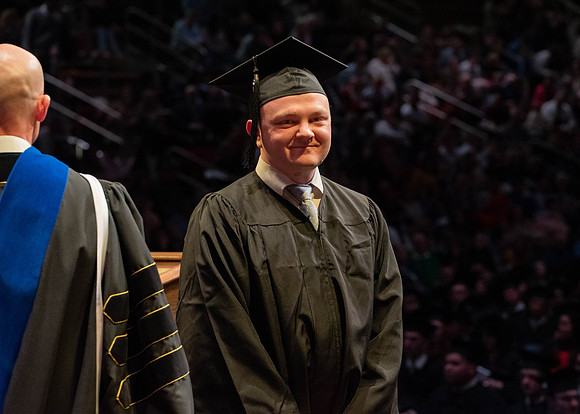 Students graduate and walk to receive their diplomas during convocation in the College of Physical Sciences and Engineering.