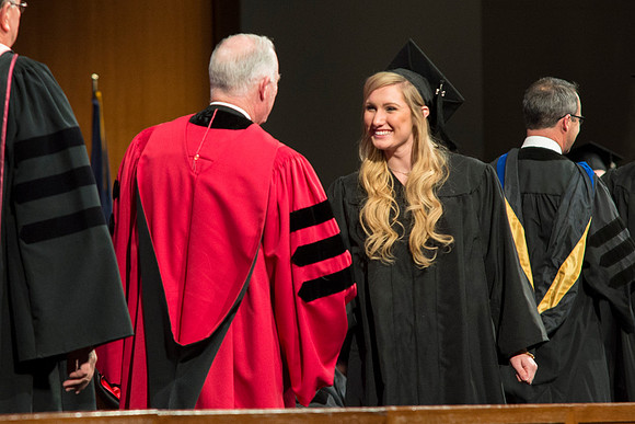 Students of the College of Agriculture and Life Sciences walk across the stage and receive their diplomas.