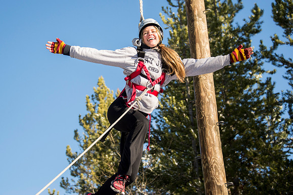 Student Haley Beautler climbs up the Power Pole at iGrow.