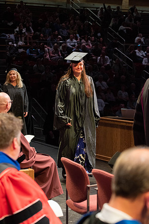 Students graduate and walk to receive their diplomas during convocation in the College of Physical Sciences and Engineering.