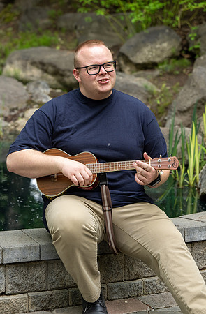 Thommy Oaks enjoying a little freetime in the gardens while playing the ukulele.