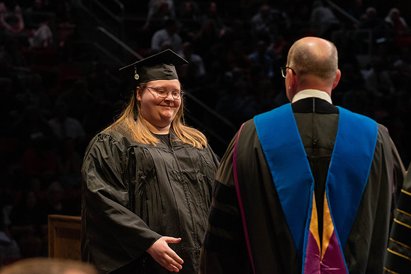 Students graduate and walk to receive their diplomas during convocation in the College of Physical Sciences and Engineering.