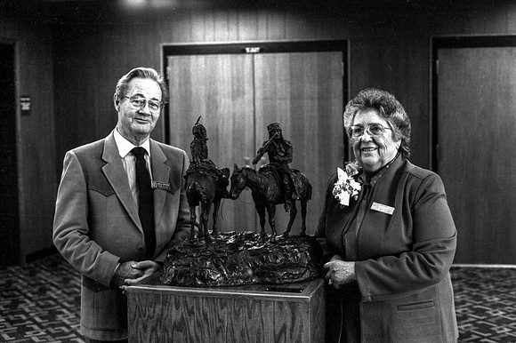 Members of the Major Donors pose around the statue
