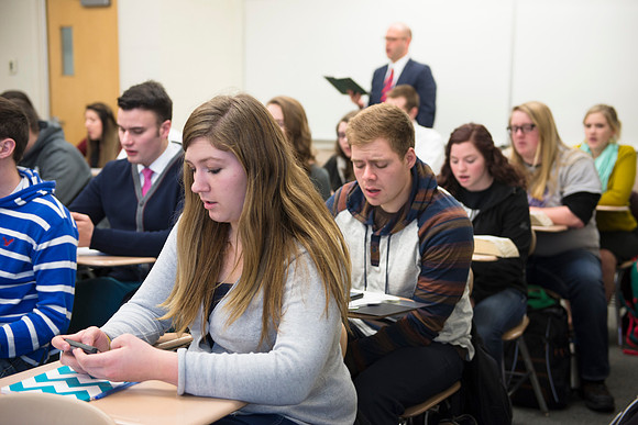 Students sing a hymn in the beginning of their religion class, Jesus Christ and the everlasting gospel.