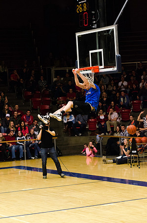 A student making a backwards slam dunk.
