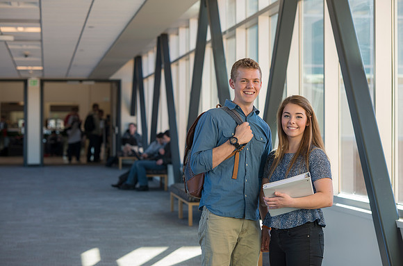 BYU-Idaho students, Collin and Martina in the Skywalk between the Manwaring Center and the McKay Library.
