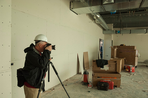 Mike Lewis, head of University Relations Photography, take pictures inside the new Science Technology Building.