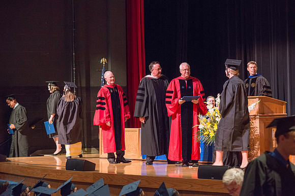 Elder Robert C. Gay of the First Quorum of the Seventy along President Kim B. Clark and John Linford, Dean of the College of Foundations and Interdisciplinary Studies present the graduates with thier
