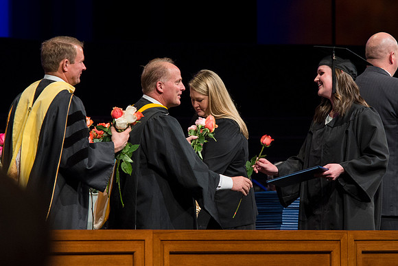 Students of the College of Agriculture and Life Sciences walk across the stage and receive their diplomas.