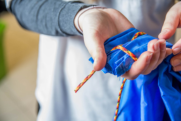Students learn to make hammocks out of parachute material.