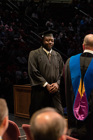 Students graduate and walk to receive their diplomas during convocation in the College of Physical Sciences and Engineering.