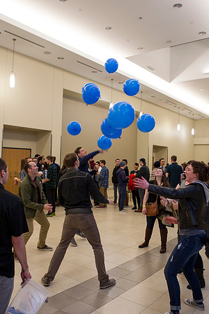 Students try to gather up all the balloons before they hit the ground.