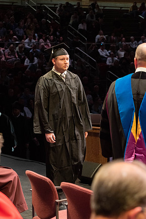 Students graduate and walk to receive their diplomas during convocation in the College of Physical Sciences and Engineering.