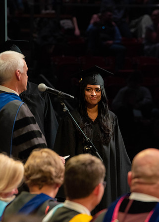 Students graduate and walk to receive their diplomas during convocation in the College of Physical Sciences and Engineering.